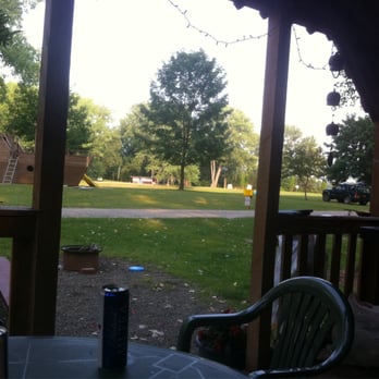 Niagara County Camping Resort - Relaxing on the cabin porch. - Campgrounds Near Me - Lockport, New York Niagara County Camping Resort - Relaxing on the cabin porch. - Campgrounds Near Me - Lockport, New York