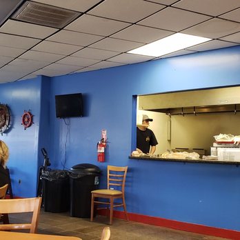 Peg Leg - a man in a yellow shirt in a restaurant - Burgers Near Me - Russellville, Arkansas Peg Leg - a man in a yellow shirt in a restaurant - Burgers Near Me - Russellville, Arkansas