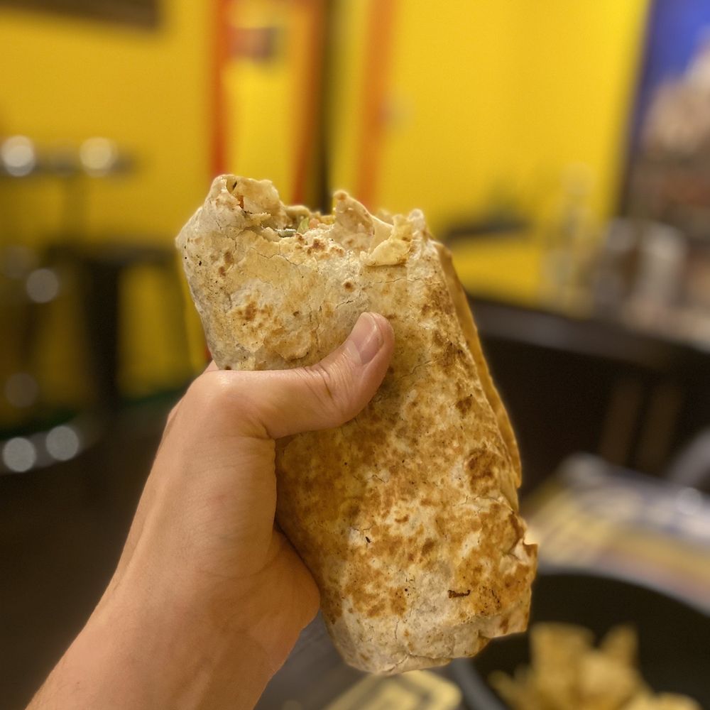 a hand holding a piece of bread a hand holding a piece of bread