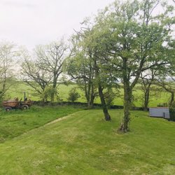 Portclew House & Cottages - Backyard view from the top of the stairs of the Upper Old Farmhouse apartment.