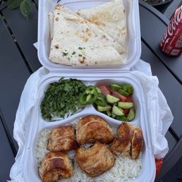 Chicken Breast plate over rice, cucumber tomato salad Chicken Breast plate over rice, cucumber tomato salad