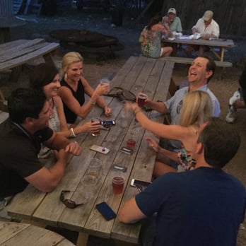 Infamous Brewing Company - Visitors playing with the NSFW Double Play deck on the outdoor tables. - Breweries Near Me - Austin, Texas Infamous Brewing Company - Visitors playing with the NSFW Double Play deck on the outdoor tables. - Breweries Near Me - Austin, Texas