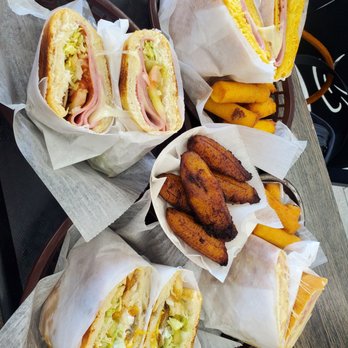 Taino’s Bakery & Restaurant - a tray of sandwiches and french fries - Puerto Rican Near Me - Azalea Park, Florida Taino’s Bakery & Restaurant - a tray of sandwiches and french fries - Puerto Rican Near Me - Azalea Park, Florida