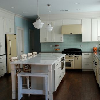 Heritage Distribution - a kitchen with white cabinets and a marble island - Flooring Near Me - Las Vegas, Nevada Heritage Distribution - a kitchen with white cabinets and a marble island - Flooring Near Me - Las Vegas, Nevada