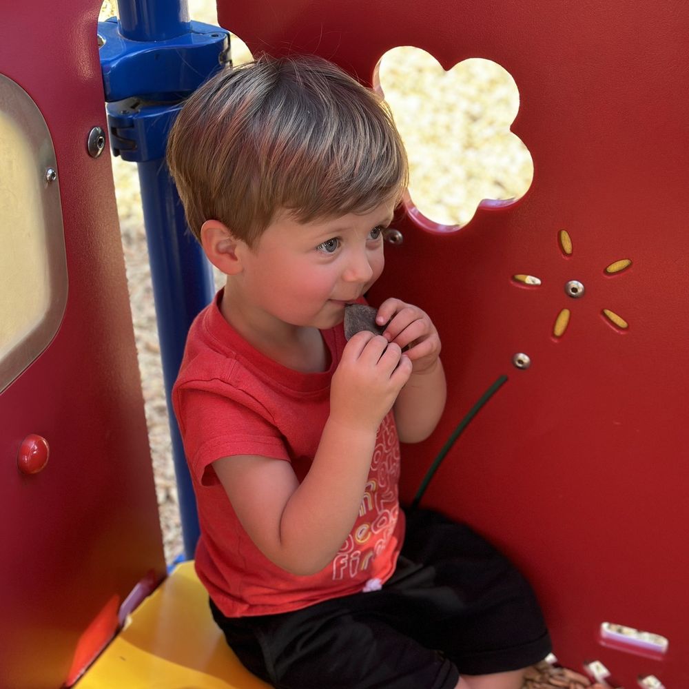 Brookside Park - Pretending to be eat his plat taco. This playhouse was fun for him. He made up fun things to do in it. - Parks Near Me - Redlands, California