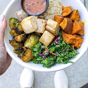 Mahana Fresh - A healthy bowl with tofu, kale crunch, roasted sweet potatoes and honey sriracha Brussels sprouts. - New American Near Me - Cary, North Carolina