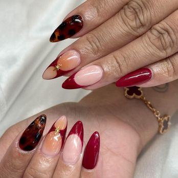 Glossy Nail Bar - Beautiful burgundy almond-shaped acrylic nails with tortoiseshell designs, French tips, and gold star accents by Chloe. - Nail Salons Near Me - Wichita, Kansas