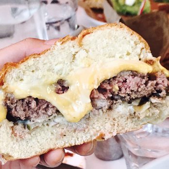 Social Kitchen & Bar - The burger! Bacon medium beef party with Gooey cheese that explodes - New American Near Me - Birmingham, Michigan