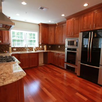 CMI Design Studio - a kitchen with wood flooring and stainless steel appliances - General Contractors Near Me - Sterling, Virginia