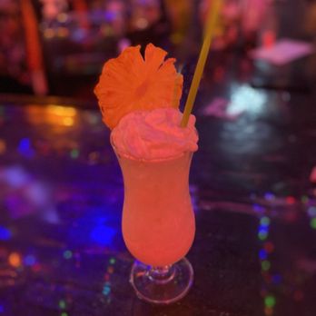 The Electric Cure - a drink with a pineapple garnish - Tiki Bars Near Me - Edgewater, Colorado The Electric Cure - a drink with a pineapple garnish - Tiki Bars Near Me - Edgewater, Colorado