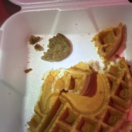 a half eaten waffle in a styrofoam container a half eaten waffle in a styrofoam container