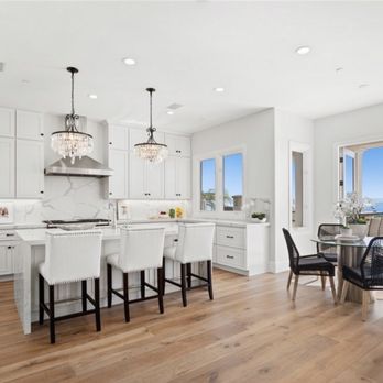 Trustwork Construction - a kitchen with a dining table and chairs - General Contractors Near Me