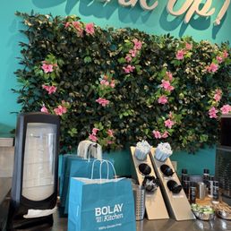 Bolay's utensils and napkins next to their drink station