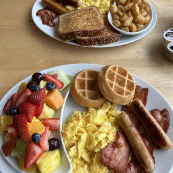 Sunny Morning - Mini waffles, French toast, scrambled eggs, bacon, sausage, breakfast potatoes and fresh fruit. - Breakfast & Brunch Near Me - Toronto, Ontario Sunny Morning - Mini waffles, French toast, scrambled eggs, bacon, sausage, breakfast potatoes and fresh fruit. - Breakfast & Brunch Near Me - Toronto, Ontario