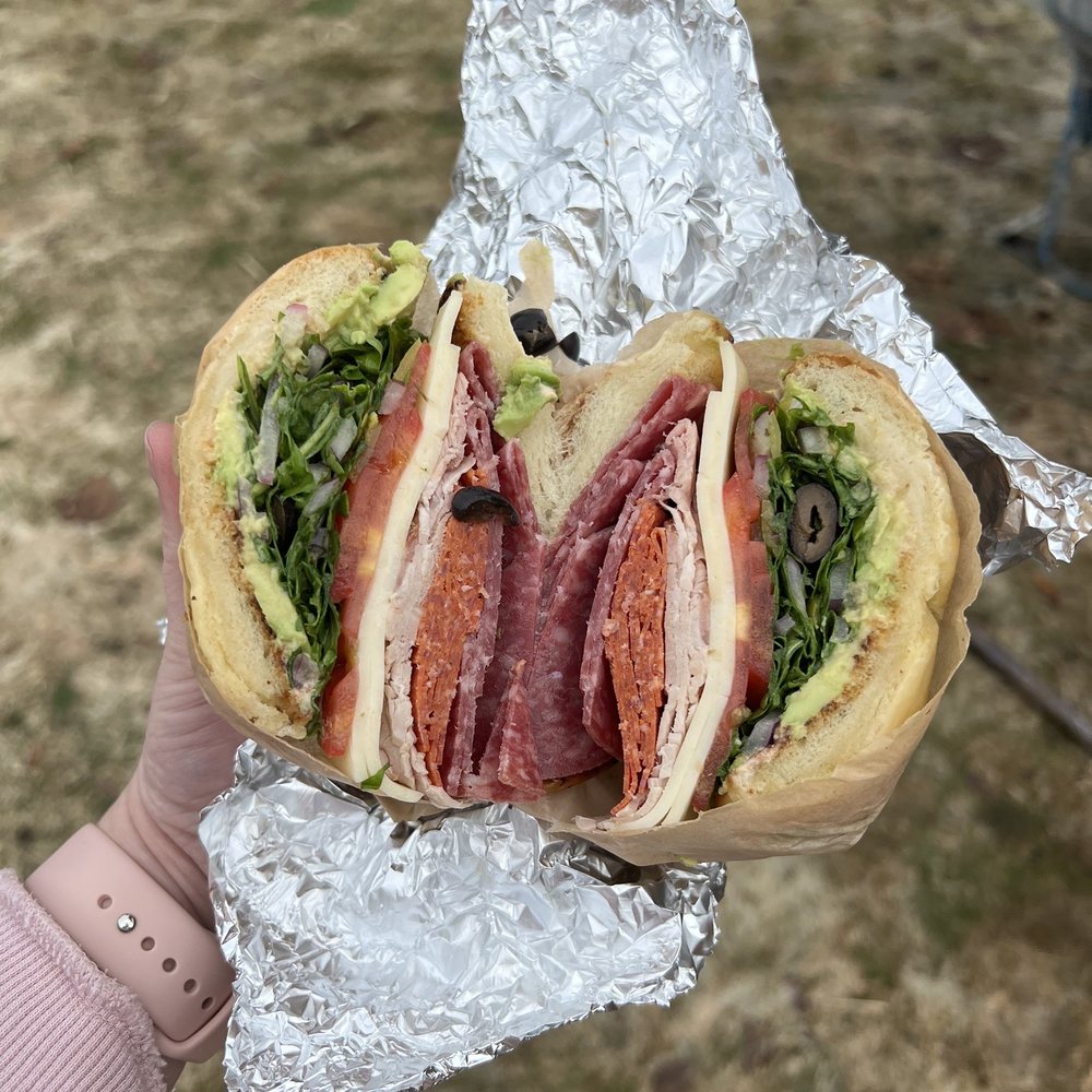 Sandos - a person holding a sandwich in their hand - Breakfast & Brunch Near Me - Spokane, Washington Sandos - a person holding a sandwich in their hand - Breakfast & Brunch Near Me - Spokane, Washington