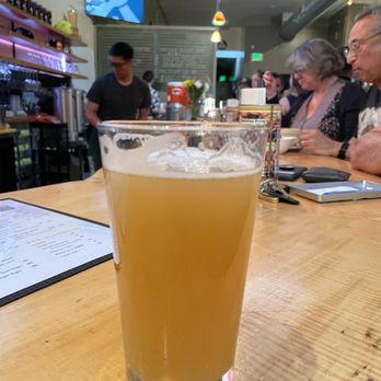 Match Point Brewing - Pineapple Cake Hazy IPA. In background: Folks eating dim sum from next door 510 Eatery. Order it and they'll deliver it to you at the bar. - Breweries Near Me - Albany, California