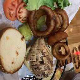 Grilled chicken sandwich and a side of onion rings Grilled chicken sandwich and a side of onion rings