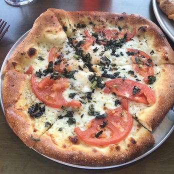 Zax Restaurant - Individual pizza- olive oil, basil, oregano, sliced tomatoes and mozzarella - Pizza Near Me - Moab, Utah Zax Restaurant - Individual pizza- olive oil, basil, oregano, sliced tomatoes and mozzarella - Pizza Near Me - Moab, Utah