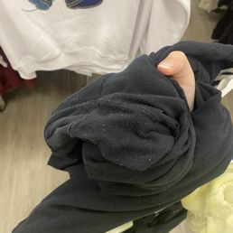 Used pants put next to the new ones. The "sold as is" sticker was hidden inside to deceive people.