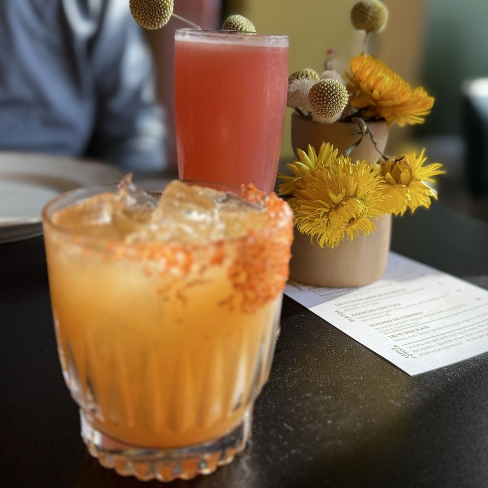 AHUMARINDO: Mezcal. tamarind, lime, cinnamon, serrano chili tincture. IXCHEL: Gin, passion fruit, rose, pepita, lemon, absinthe rinse AHUMARINDO: Mezcal. tamarind, lime, cinnamon, serrano chili tincture. IXCHEL: Gin, passion fruit, rose, pepita, lemon, absinthe rinse