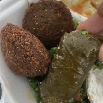 The Green Olive - Grape leaf wrap on the right and falafel on the left. - Mediterranean Near Me - Compton, California The Green Olive - Grape leaf wrap on the right and falafel on the left. - Mediterranean Near Me - Compton, California