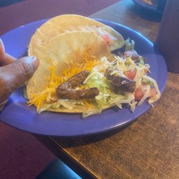 a hand holding a taco