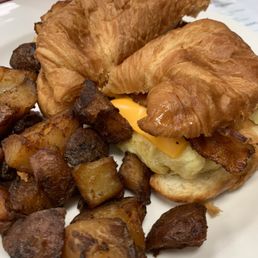 Green Pharmacy luncheonette bacon egg & cheese on a croissant with breakfast potatoes YUM Green Pharmacy luncheonette bacon egg & cheese on a croissant with breakfast potatoes YUM