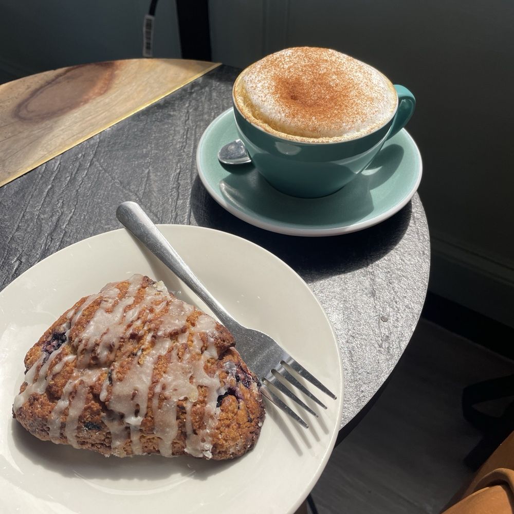Java Owl Coffee House - Blueberry scone and cappuccino with cinnamon topping - Coffee & Tea Near Me - Nassau Bay, Texas