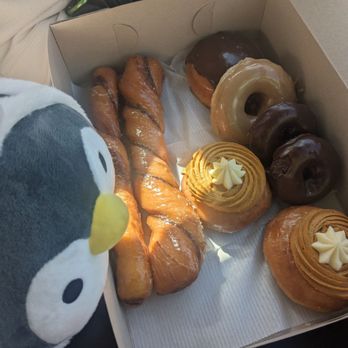 Clockwise, starting from the left: tiger tail donuts, Bavarian cream donut, maple donut, double-chocolate donuts, pumpkin donuts.
