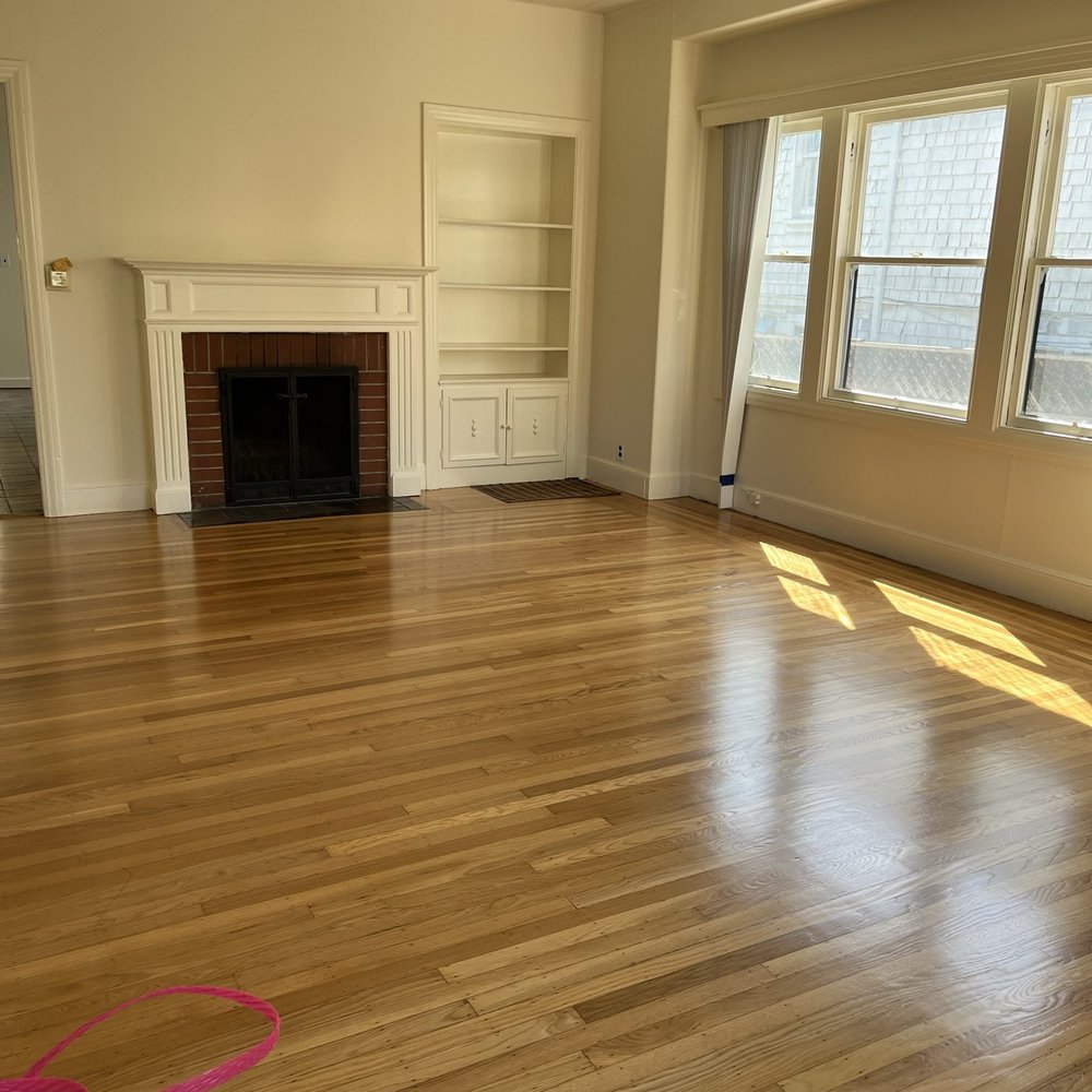 a living room with hard wood floors a living room with hard wood floors