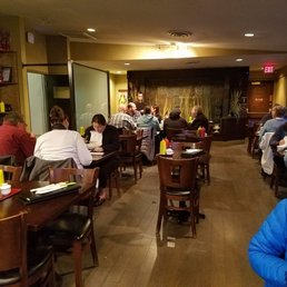 people sitting at tables in a restaurant