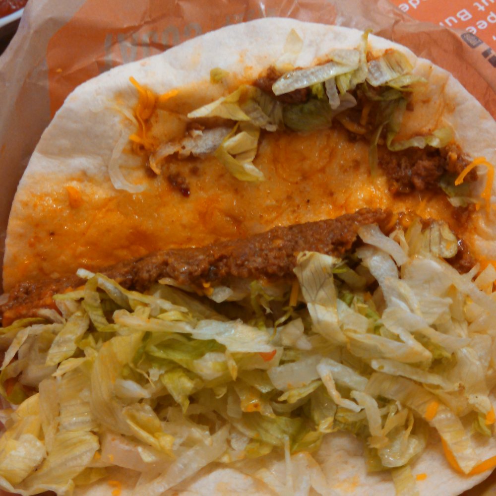 Taco John's - a taco with cheese and lettuce - Mexican Near Me - Watertown, South Dakota Taco John's - a taco with cheese and lettuce - Mexican Near Me - Watertown, South Dakota