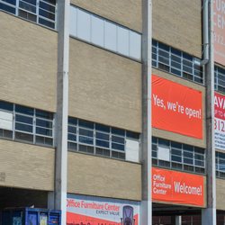 Office Furniture Center - Enter below these signs!  We have free on-site secure parking for all OFC customers!