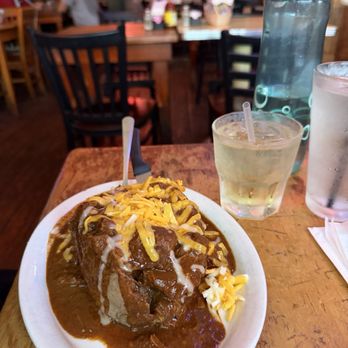 Texas Chili Parlor - Can't see how large the baked potato is under all that chili. - American Near Me - Austin, Texas Texas Chili Parlor - Can't see how large the baked potato is under all that chili. - American Near Me - Austin, Texas