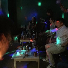 a group of people in a dark room a group of people in a dark room