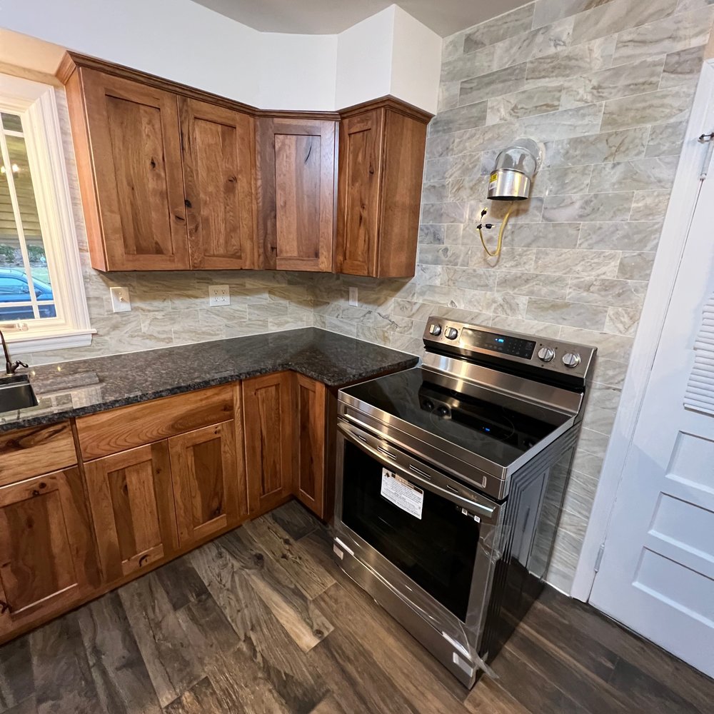 VB Renovations - a kitchen with wood cabinets and stainless steel appliances - General Contractors Near Me VB Renovations - a kitchen with wood cabinets and stainless steel appliances - General Contractors Near Me