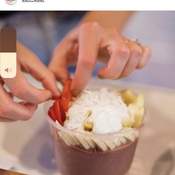 Zen Acai - a person putting toppings on a dessert - Acai Bowls Near Me - Draper, Utah Zen Acai - a person putting toppings on a dessert - Acai Bowls Near Me - Draper, Utah