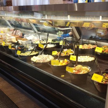 Gino's Italian Deli - a woman standing in front of a deli counter - Delis Near Me - Madison, Wisconsin Gino's Italian Deli - a woman standing in front of a deli counter - Delis Near Me - Madison, Wisconsin