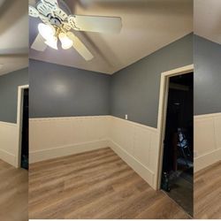 Premier Solutions - Finished room with new flooring, custom wall panels, fresh paint, and ceiling fan. Complete transformation.