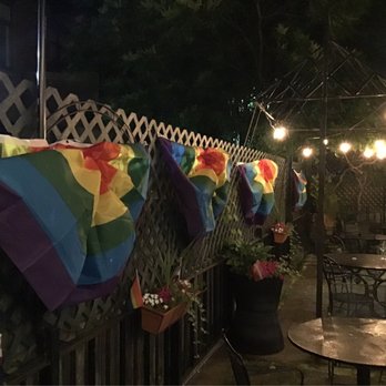 Cathedral Station - a patio with a table, chairs, and umbrellas - Sports Bars Near Me - Boston, Massachusetts