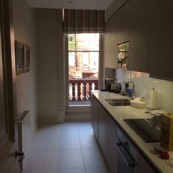 The Apartments by The Sloane Club - Kitchen and Laundry Room