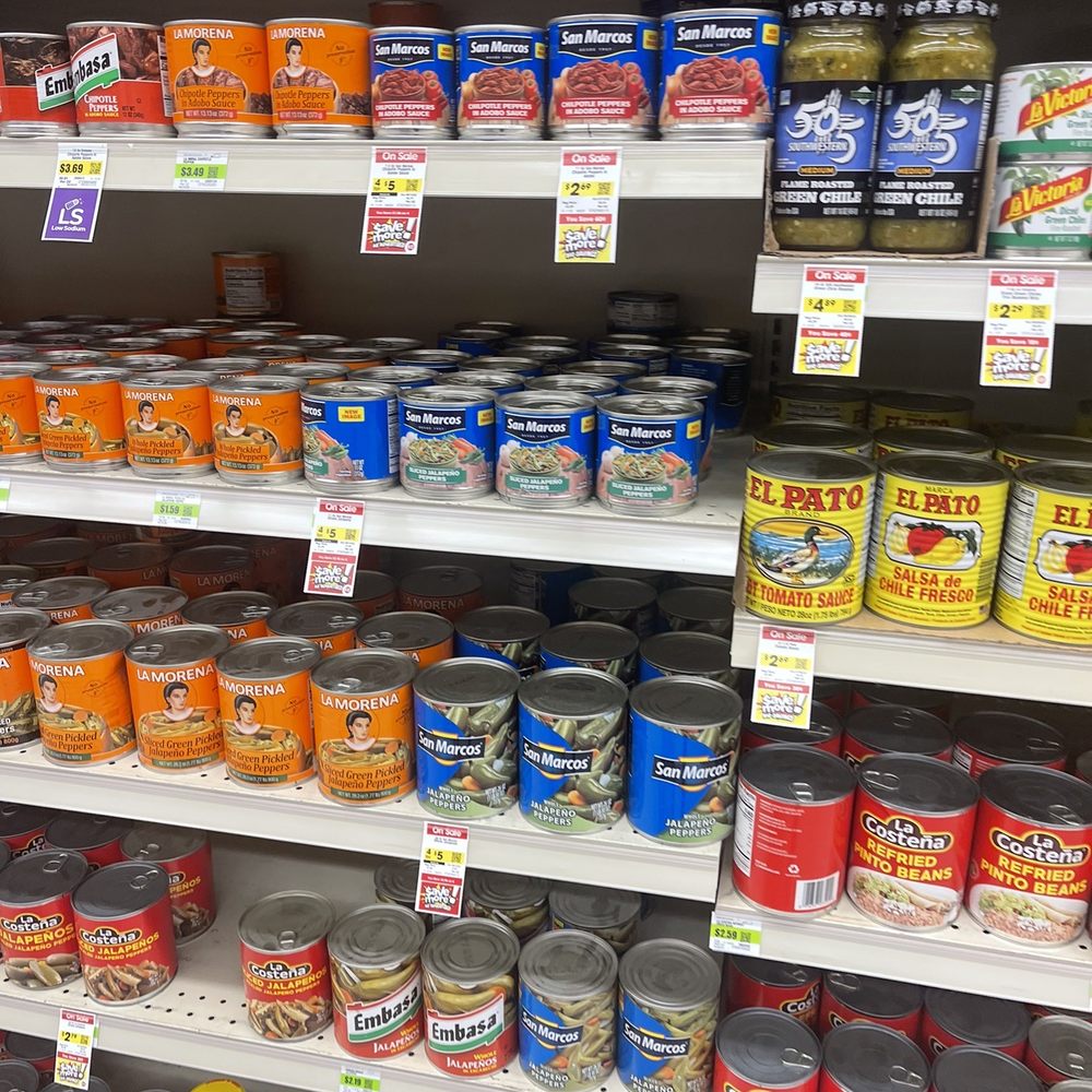 canned food on shelves in a grocery store canned food on shelves in a grocery store