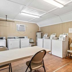Wagon Train RV Park - On site laundry facility with washers dryers and seating area for guests to take care of chores during their stay