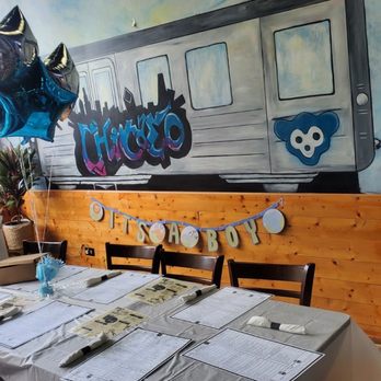 Le Café Station Grill - a woman standing in front of a mural of a train - Breakfast & Brunch Near Me - Chicago, Illinois Le Café Station Grill - a woman standing in front of a mural of a train - Breakfast & Brunch Near Me - Chicago, Illinois