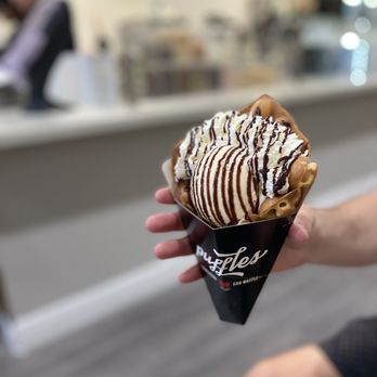 Puffles - a person holding a cone of ice cream - Desserts Near Me - Hollywood, Florida Puffles - a person holding a cone of ice cream - Desserts Near Me - Hollywood, Florida