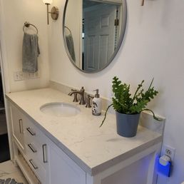 Vanity, faucet, mirror, and sconces. Vanity, faucet, mirror, and sconces.
