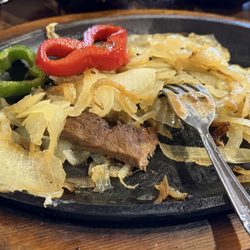 Vaqueros Mexican Grille - The only vegetables served with the unseasoned sandbox dry fajita meat. Literally a plate of onions with grey dry meat. Nasty.