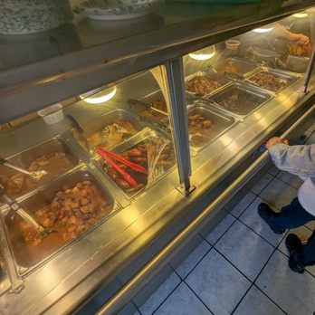 Kababayan - a child looking at food in a display case - Filipino Near Me - San Francisco, California