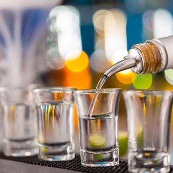 Goldfinger - a bartender pouring vodka into shot glasses - Dance Clubs Near Me - Sunrise, Florida Goldfinger - a bartender pouring vodka into shot glasses - Dance Clubs Near Me - Sunrise, Florida