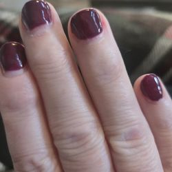 Red colored nails painted badly